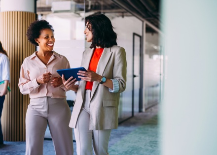 Professional business women discussing workplace culture in Latin America
