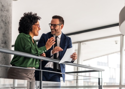 Two professional colleagues sharing ideas in a modern office