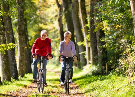 Couple riding bicycles through the forests during Liechtenstein’s public holidays