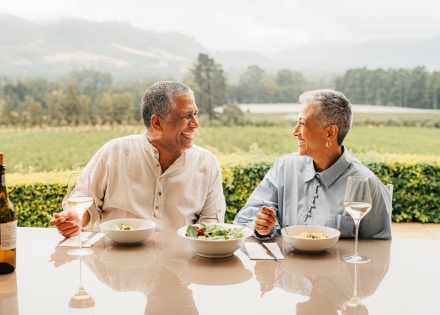 Senior couple eating food at a vineyard on a Kazakhstan public holiday