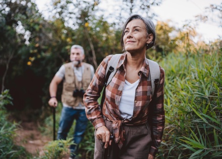 Senior couple walking on forest mountain trail while enjoying a Rwanda public holiday