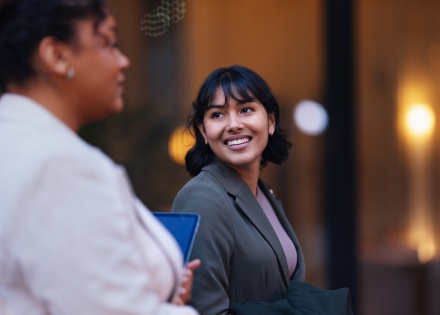 Smiling businesswoman talks with a colleague about workplace culture in Nepal