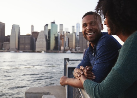 Young Indonesian couple standing on the quayside