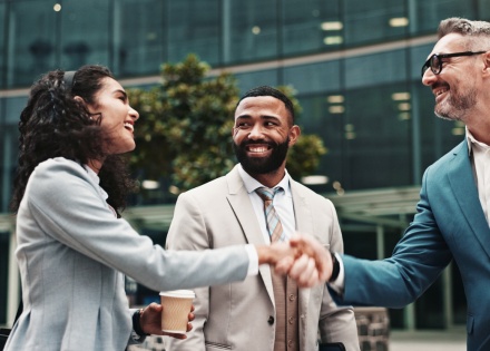 Business people shaking hands and displaying proper business etiquette in Haiti
