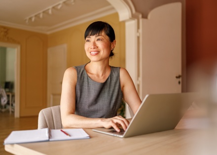 Businesswoman looking away while working on payroll taxes in Suriname