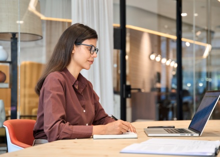 Female data entry specialist working on a laptop