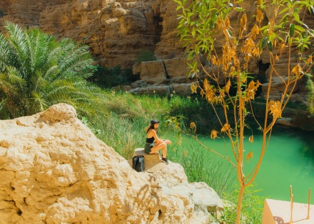 Hiker at Wadi Ash Shab enjoying Oman’s public holidays