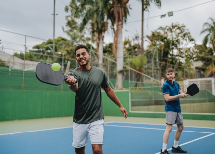 Friends playing pickleball together during Liberia’s public holidays