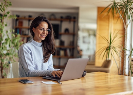 Project coordinator working on a laptop at home