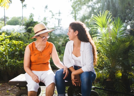 Two women sitting on a bench enjoying a Haitian public holiday