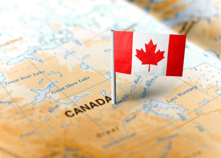 Canada flag pinned into a map of Canada