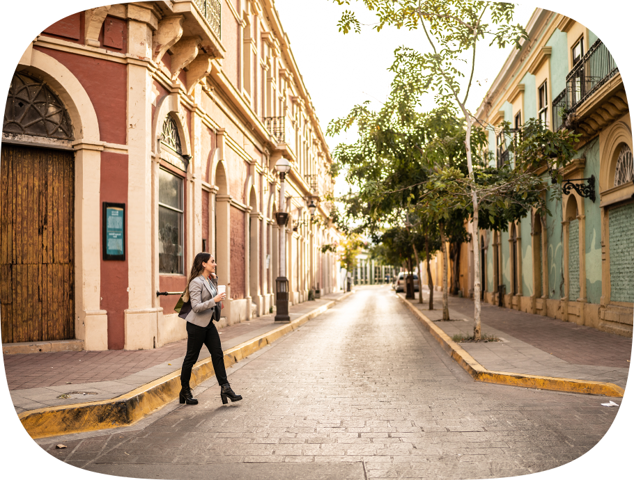 Professional woman crossing a cobblestone street in an old town city center