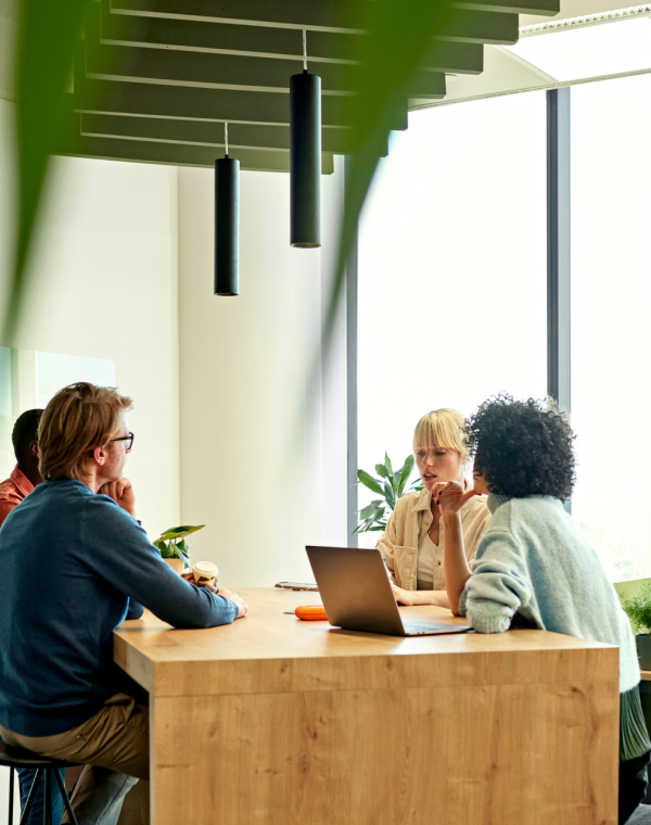 Co-workers discuss a project in a co-working space in Spain
