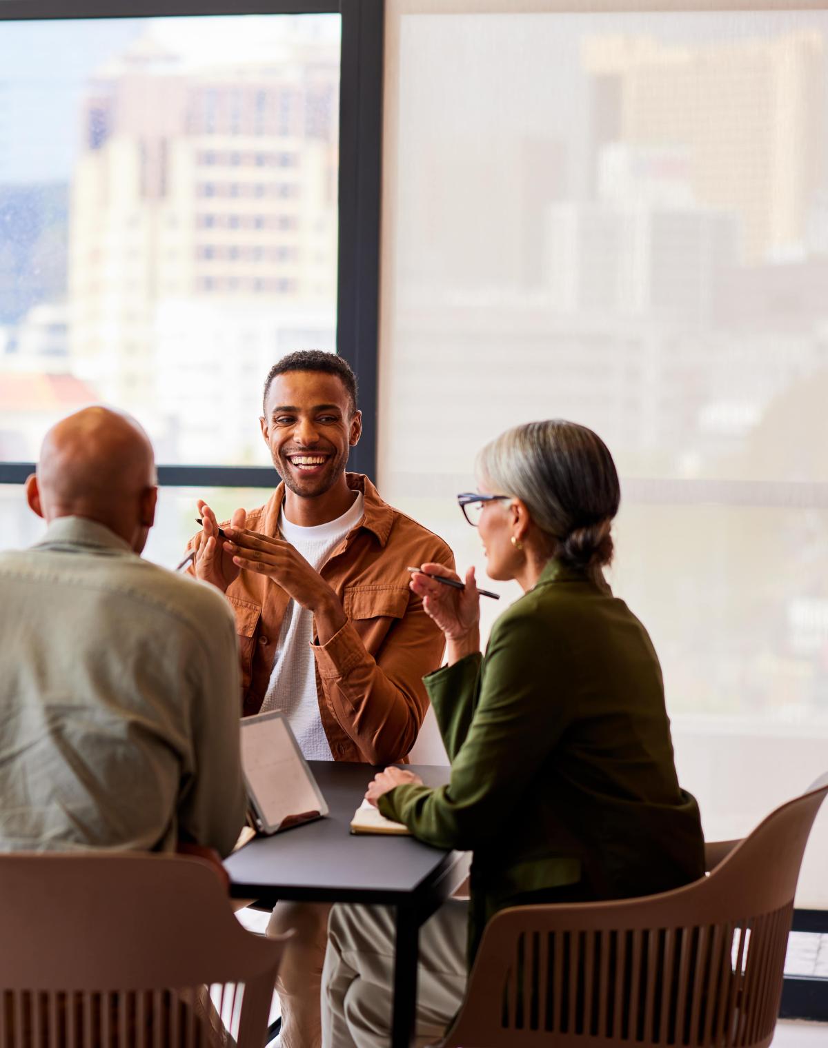 Team of five in bright conference room discussing Pebl EOR.