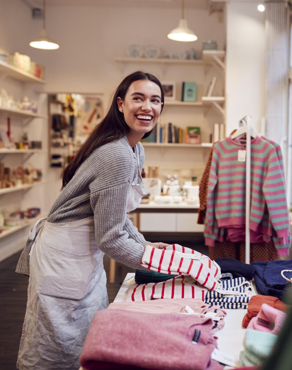 Boutique retail owner restocking store after using Pebl for EOR services.