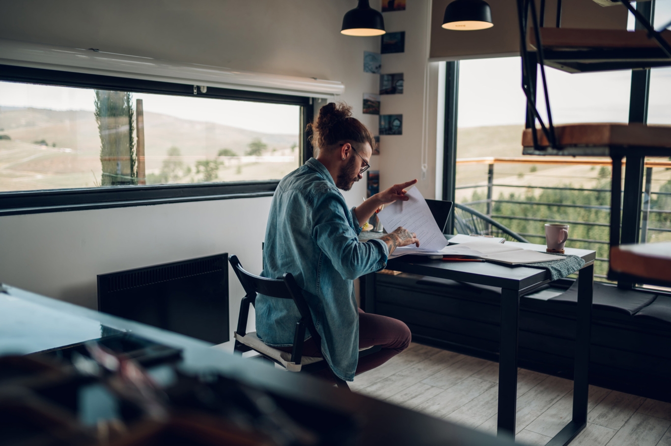 Global employer reviewing papers on a desk.