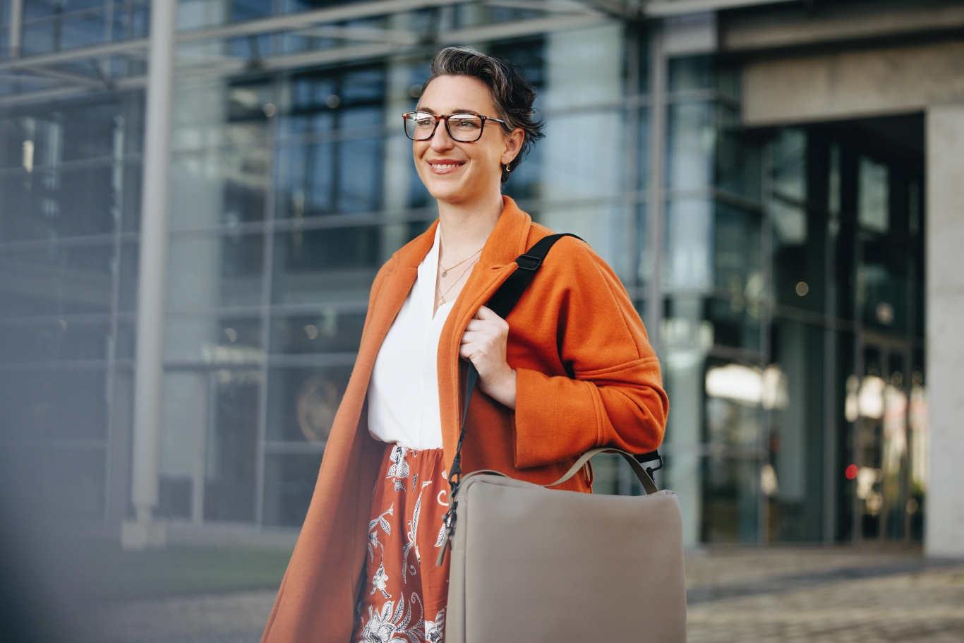 Woman in business attire confidently walking outside after partnering with Pebl.