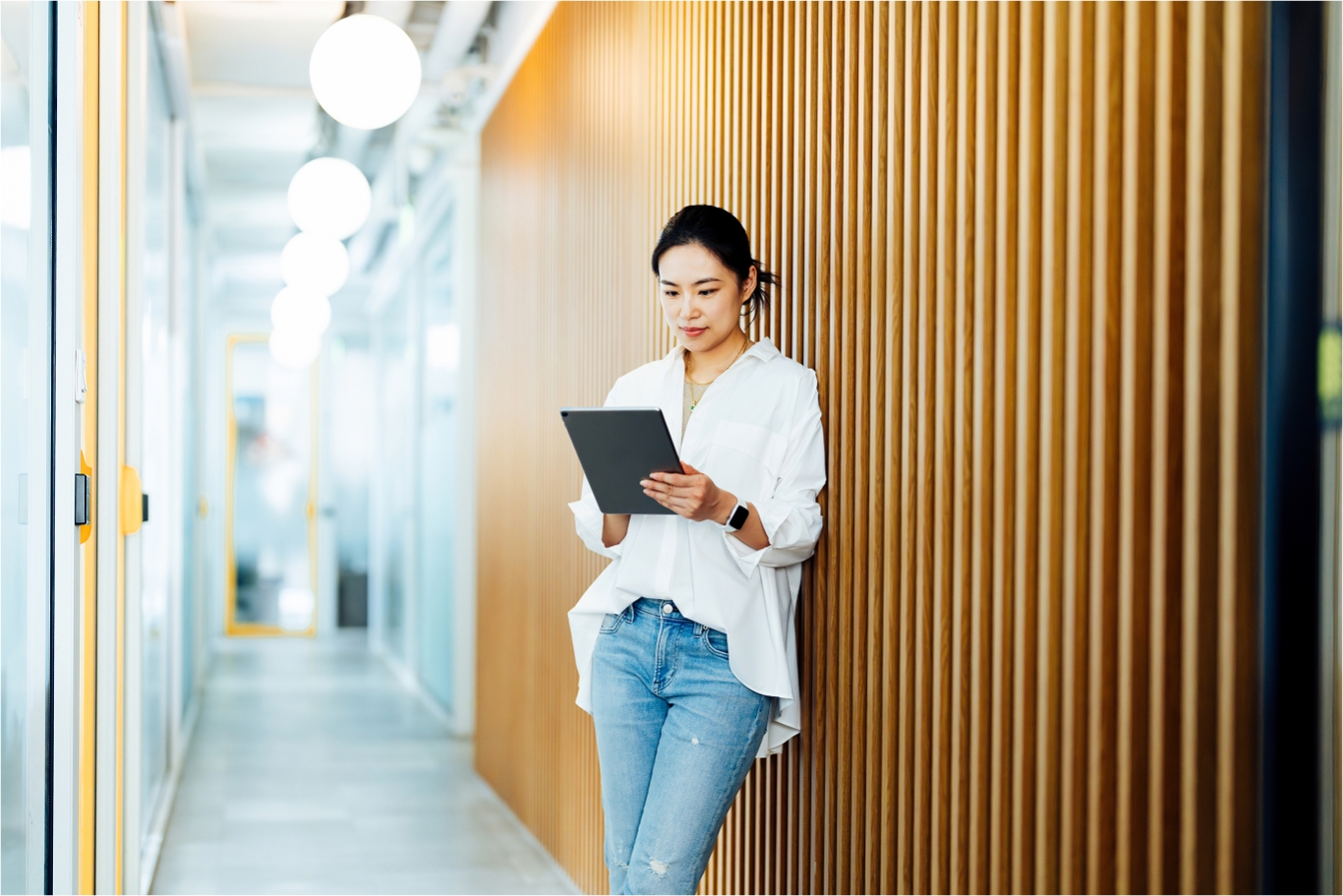 Employee walking through an AI company office with a laptop, representing how Pebl supports AI companies