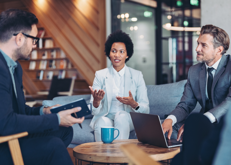 Group in an office setting discussing acquihire strategy & process.