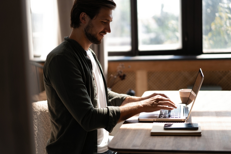 Man working remotely researching how to get a work visa for his employees