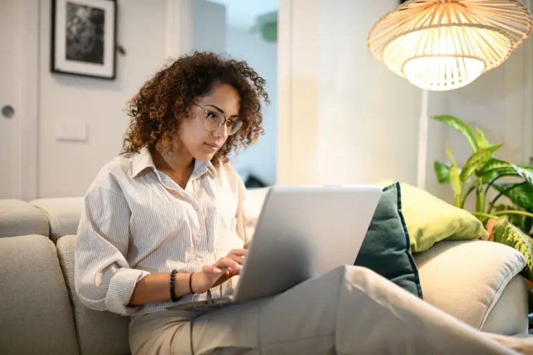 Woman-using-laptop-on-sofa.jpg