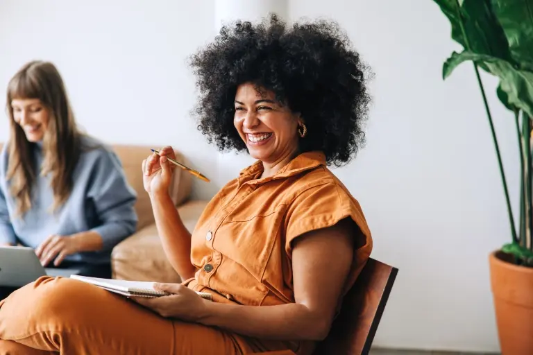 businesswoman-smiling-cheerfully-while-sitting-in-a-meeting.jpg