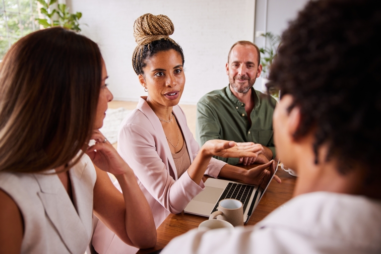 businesswomantaking-during-a-meeting-with-coworkers-in-an-office.jpg