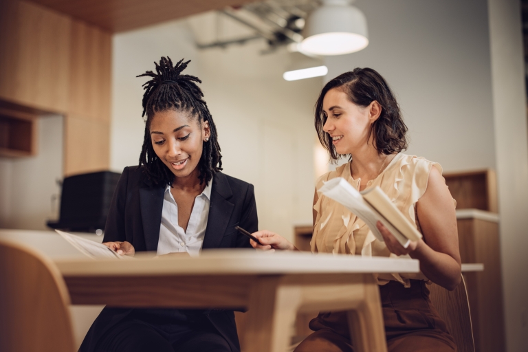 Two colleagues discuss their research on Philippines work visas