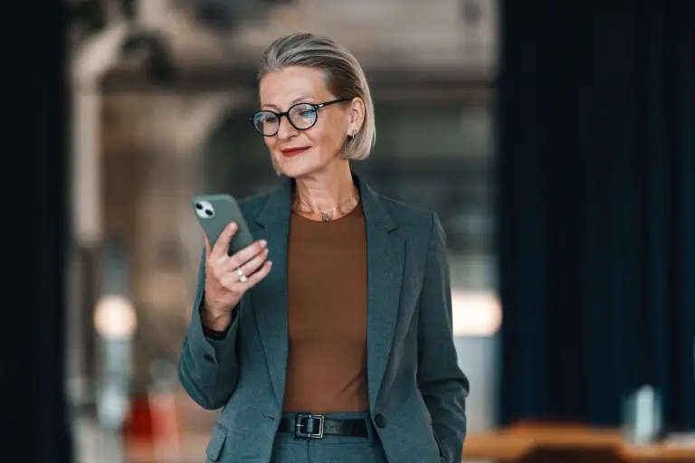 Business-Woman-Using-Her-Mobile-Phone-at-the-Office.jpg