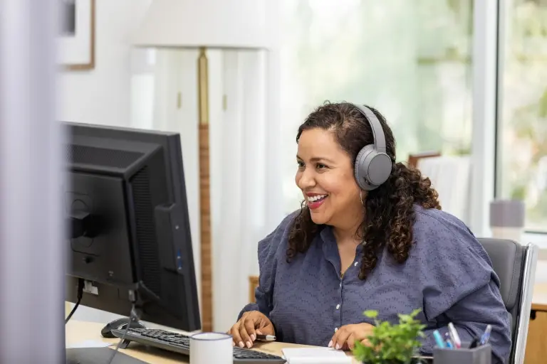 Businesswoman-smiles-as-she-meets-with-client-virtually.jpg