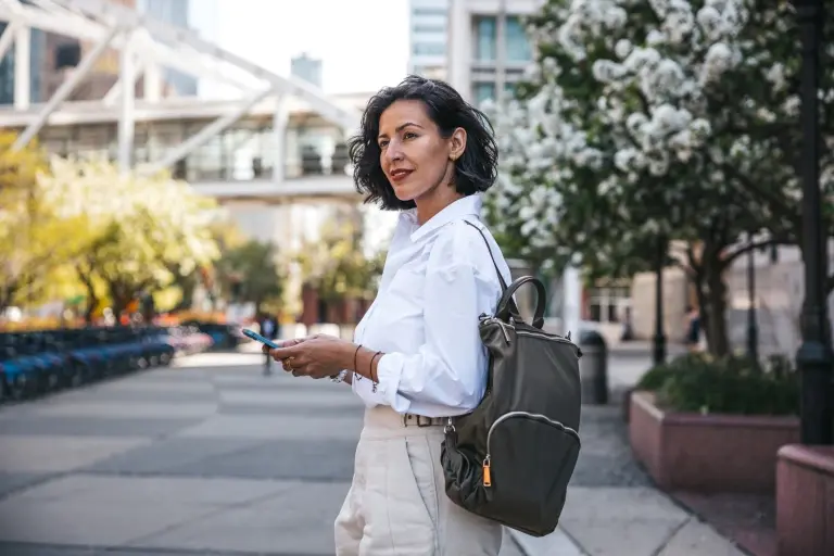 Businesswoman-standing-outside-holding-her-phone.jpg