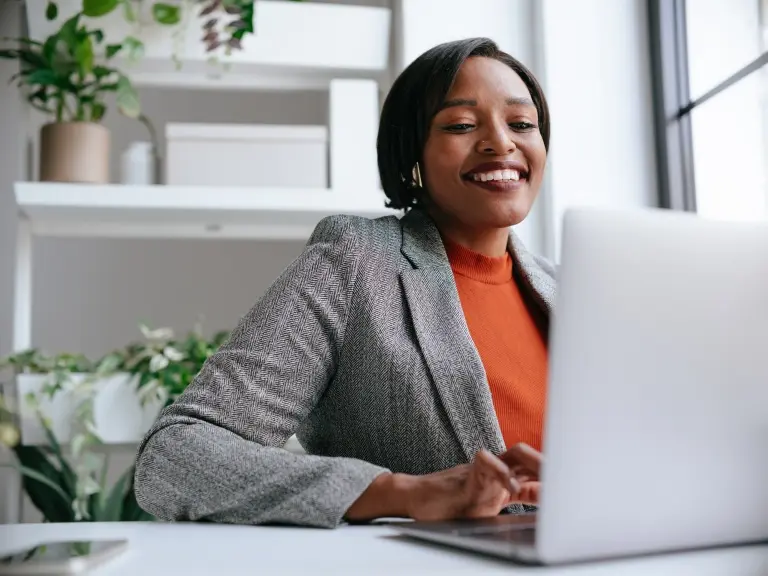 Professional-Woman-Working-on-Laptop-in-Modern-Office.jpg
