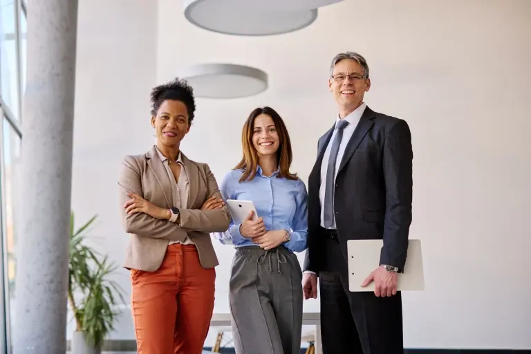 business-team-holding-digital-tablet-and-posing-in-office.jpg
