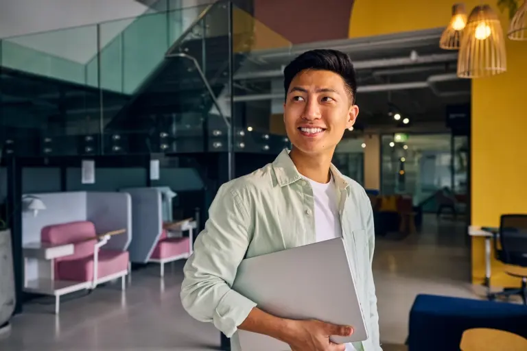 man-holding-laptop-in-modern-office.jpg