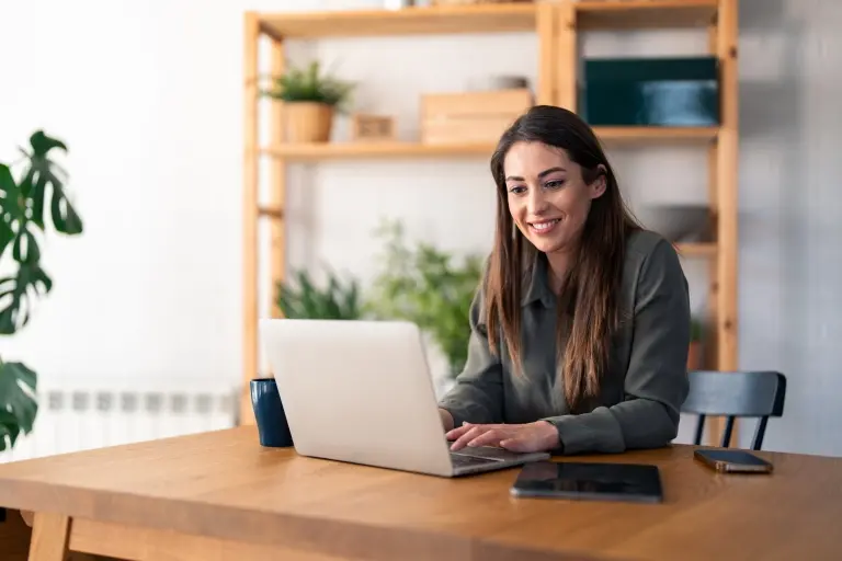 woman-typing-on-laptop-computer-while-sitting-at-table-in-home-office.jpg