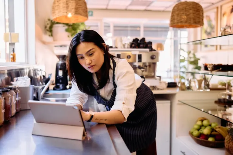 business-owner-working-in-cafe-with-digital-tablet.jpg