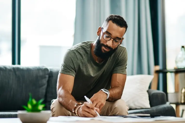 young-man-going-over-his-finances-at-home.jpg