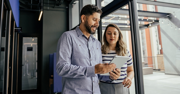 Woman and man looking at tablet