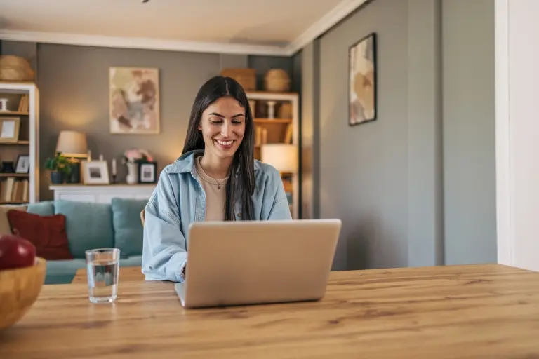 woman-sitting-at-the-table-in-the-living-room-at-home and using a laptop..jpg