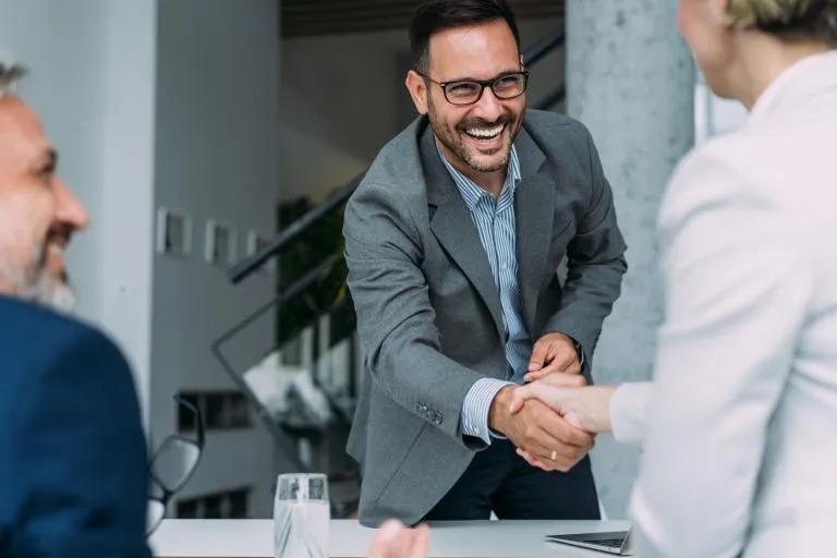 Business-people-handshaking-across-the-table.jpg