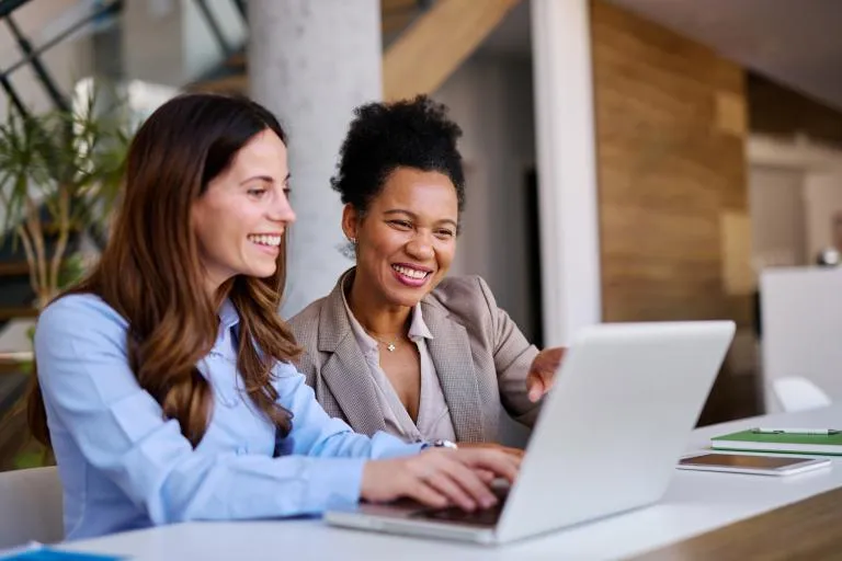 businesswomen-working-together-on-a-laptop.jpg