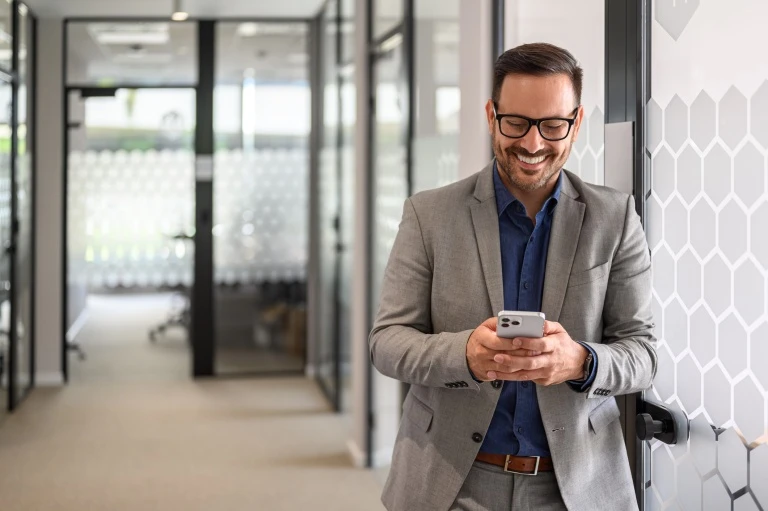businessman-using-smart-phone-and-smiling (1).jpg