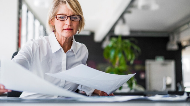 blog-image--Can-You-Trust-Your-Employer-of Records-Burden-and-VAT Quotes-Three-Reasons-For-Caution woman reviewing employer burden quotes