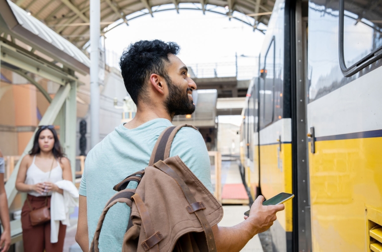 How to Pay an Independent Contractor in India: A Guide for Global Companies Young man standing on train station platform in India.