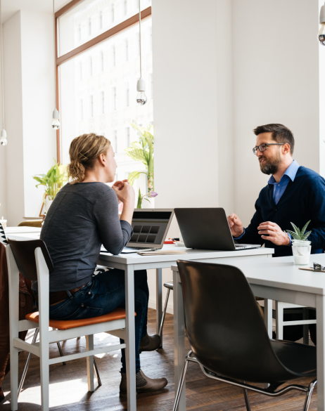coworkers talking over a desk