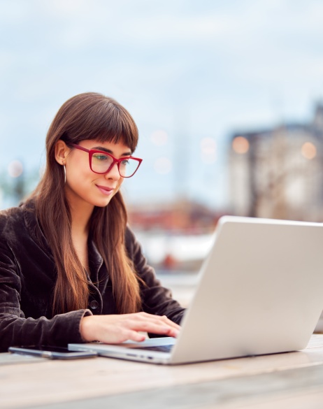Woman reviewing global HR services on laptop.