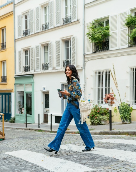 Woman walking through the streets of Paris, France.