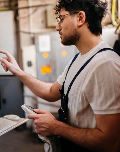 Small business owner checking production quality after using EOR for retail global expansion.