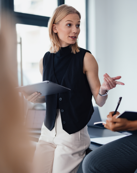 Professional woman in office setting providing HR strategy for hiring freezes. 