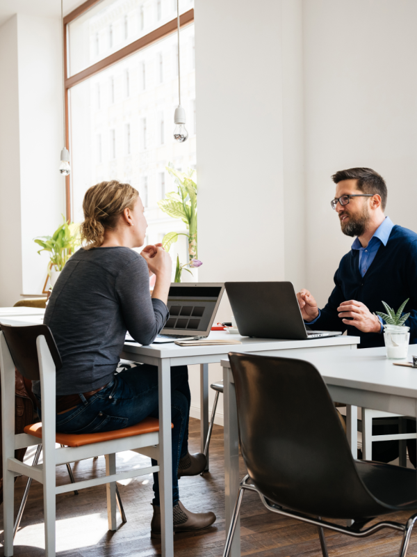 coworkers talking over a desk